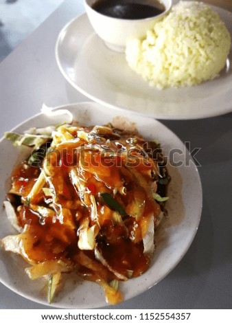 Malay style chicken rice topped with sauces and served with hot rice.
