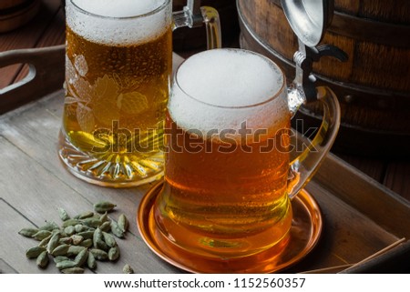 Light foam beer in a glass on an old background