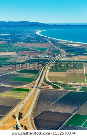 Pacific coast of California with farmland around freeway 101 and Monterey Bay visible in the up right corner. The picture was taken in the early July.
