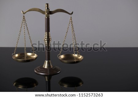 Scales of justice on gray background.