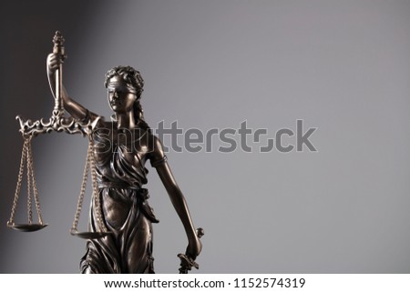 Statue of justice on gray background.