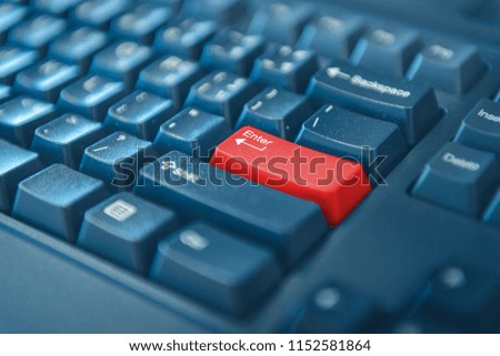 Close-up of computer keyboard with red button. selected focus on enter button.
