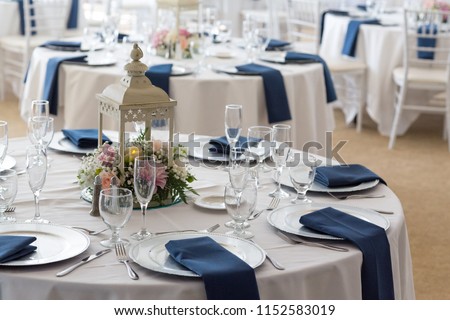 Wedding reception tables setup before guests arrive.  Royalty-Free Stock Photo #1152583019