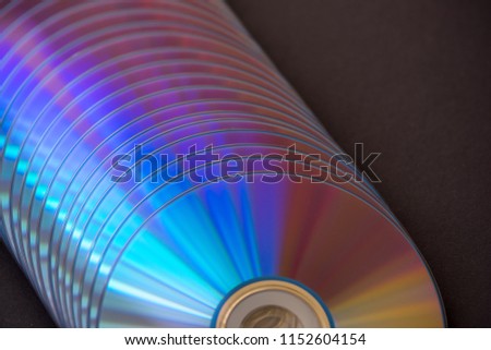 sd and dvd disks on a dark background. large stack