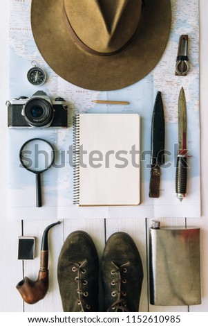 Adventure planning flat lay. Travel vintage gear on map. Including boots, smoking pipe, hat, notepad. Exploring, hiking empty space poster, postcard, template.