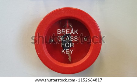 Break glass for key to release an emergency key