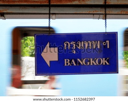 signage at a railway station show direction to Bangkok, see the train background