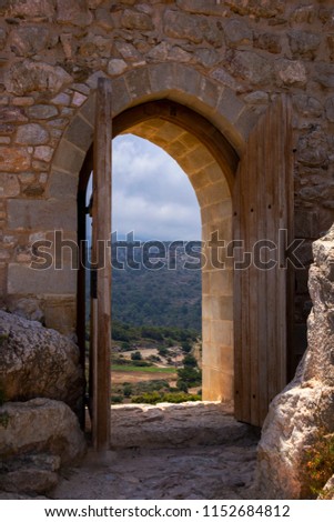 open door to the ancient fortress on the top of the hill through which beautiful views of the surrounding nature, mountains, forests, hills