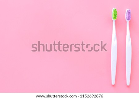 Clean teeth. Toothbrushes on pink background top view copy space