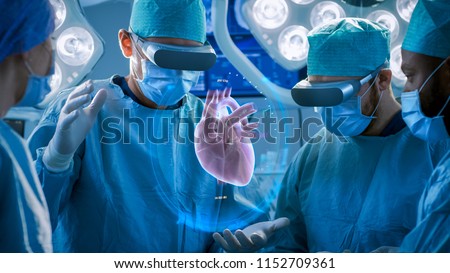 Surgeons Perform Heart Surgery Using Augmented Reality Technology. Difficult Heart Transplant Operation Using 3D Animation and Gestures. Interactive Animation Shows Vital Signs. Futuristic Hospital. Royalty-Free Stock Photo #1152709361