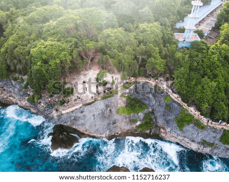 Aerial view of coral cliffs with sea waves.