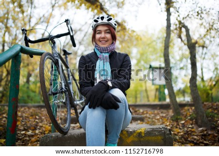 Image of girl sitting on stairs next to bicycle
