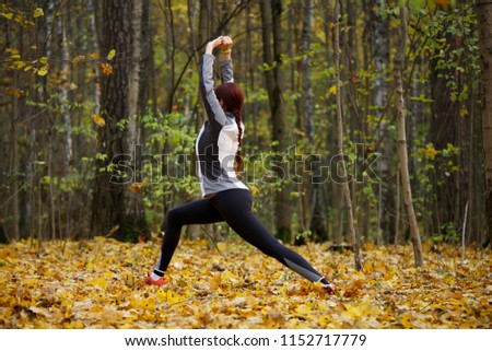 Photo of sporty fitness girl doing stretching exercises in fresh air