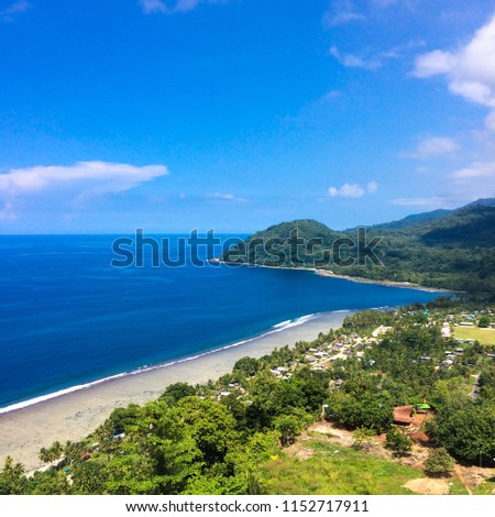 Aerial drone view of the white beach with blue sea in the summer