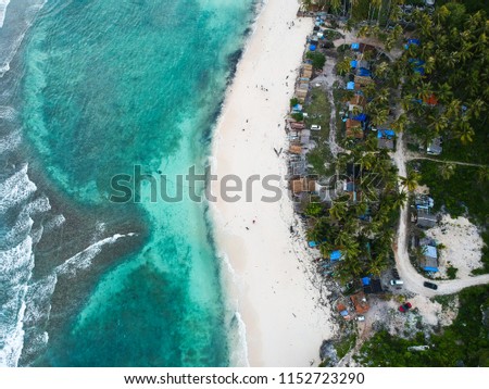 Aerial view of the white beach with blue sea in the summer
