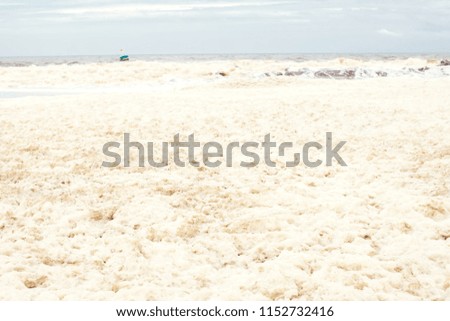 sea and skies and a beach covered in sea foam