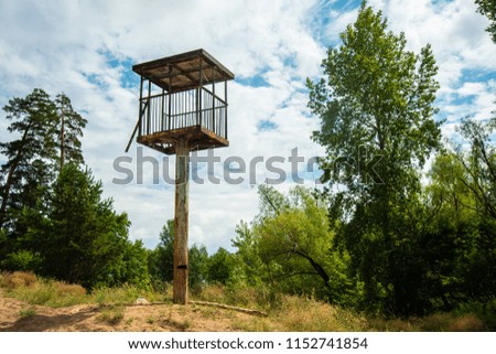 high watch tower in a beautiful landscape on sky backround