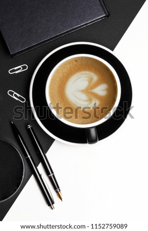 Set of black identity elements and cup of coffee on black and white paper background. Branding mockup