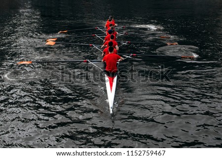 rowers rowing in the dark water. The concept of team sports Royalty-Free Stock Photo #1152759467