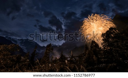 fireworks in the wood with East wall of Monte Rosa and mountains landscape in summer evening