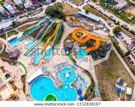 Aerial drone view looking straight down from above colorful summer time fun at water park. Top view