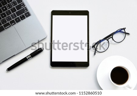 Top view tablet,pen,glasses and Laptop on office desk.Top view with copy space.