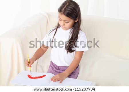 Little girl holding a brush and starting drawing