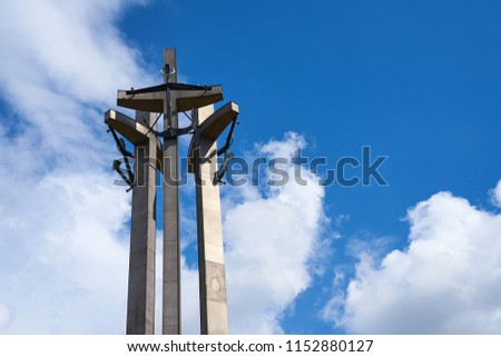            Three Crosses with anchors, a monument to the fallen workers of shipyard at Solidarnosti Square in Gdansk, Poland against a blue cloud sky. Copy space for text.                    
