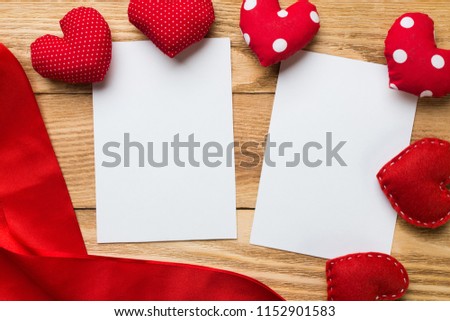 Love hearts and sheet of blank paper on wooden table