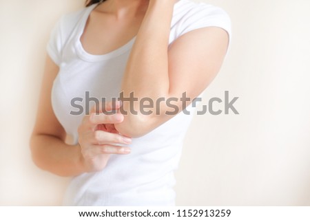 Woman applying elbow cream,lotion , Hygiene skin body care concept. Royalty-Free Stock Photo #1152913259