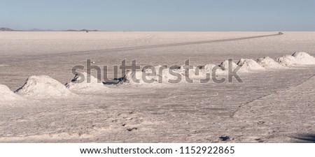 Salt mining in Colchani with salt pyramids, ready for harvest, in the Uyuni salt flat (Salar de Uyuni), Bolivia, South America.