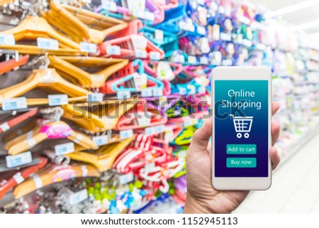 Men hand holding modern mobile phone with online shopping application on Supermarket blur background, business concept