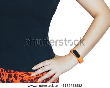 Woman in sportswear with a fitness bracelet on her hand on a white background isolated.