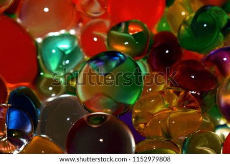 Bright blurred background. Photo of colored hydrogel balls.