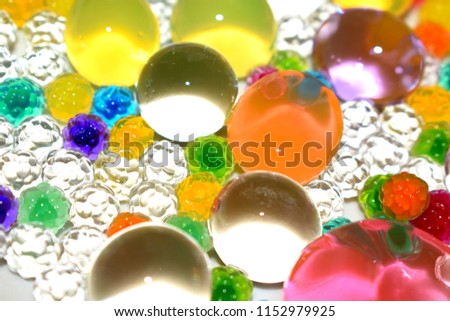 Bright blurred background. Photo of colored hydrogel balls.