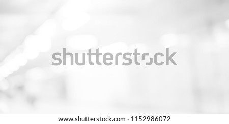 abstract blurred of white silver background of modern contemporary interior office with bokeh light for presentation design concept