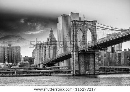 Brooklyn Bridge with  Manhattan skyline panorama in the afternoon with cloud and river reflection over East River in New York City