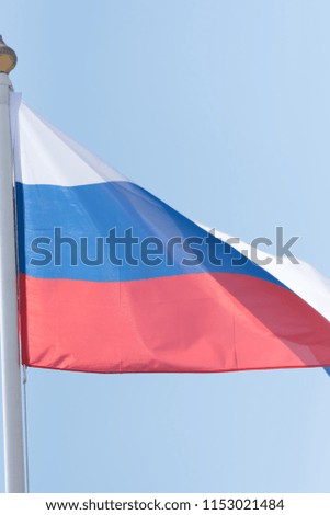 Russian flag against blue sky