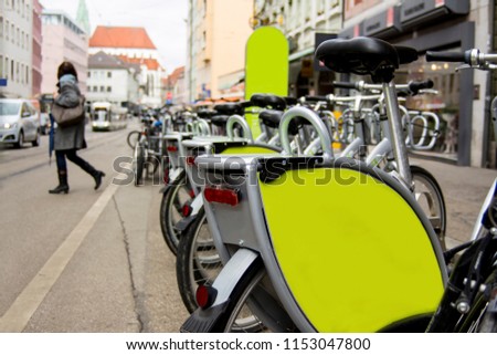 Bikes bicycles parked on a busy road in the city of augsburg with green space for text or logo copyspace