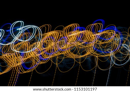 Colorful light painting with circular shapes and abstract black background.