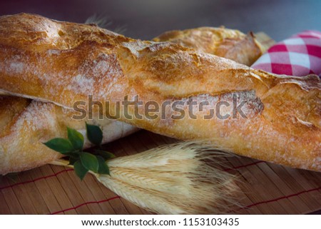 
Fresh French baguette on top of a wooden table. fresh bread