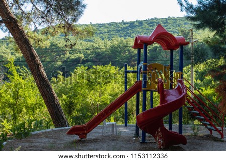 a playground on mountain with wide landscape at background.