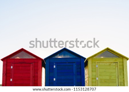 Cabins changers for bathers on a beach of the Mediterranean in summer, colored blue, yellow and red.