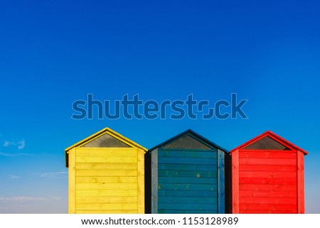 Cabins changers for bathers on a beach of the Mediterranean in summer, colored blue, yellow and red.