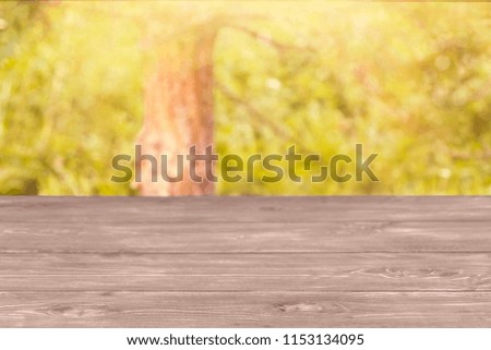 The surface of the wooden table and the blurred yellow-green background. Template mock up for display of product