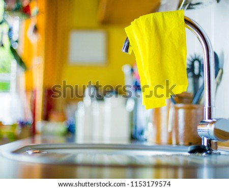 An unhygienic dishcloth lies on a sink Royalty-Free Stock Photo #1153179574