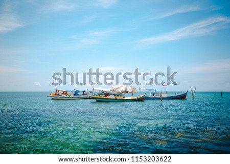 Traditional boats with rocks in the background