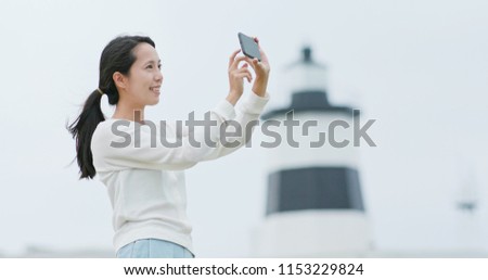 Woman use of cellphone to take photo at outdoor