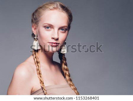 Beautiful woman with pigtails hair beauty model over gray background