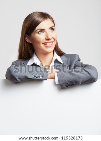 Portrait of young business woman with blank white board on gray isolated